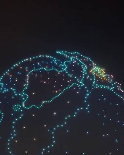 Drones drawing a globe in the night sky